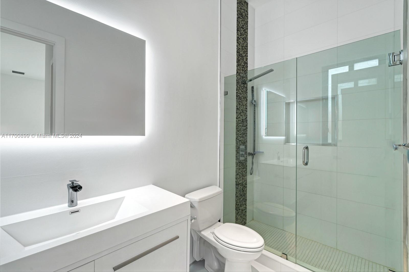 2040 Northeast 121st Road North Miami, FL 33181 - Photo 31 of 43 a bathroom with a sink a toilet and shower