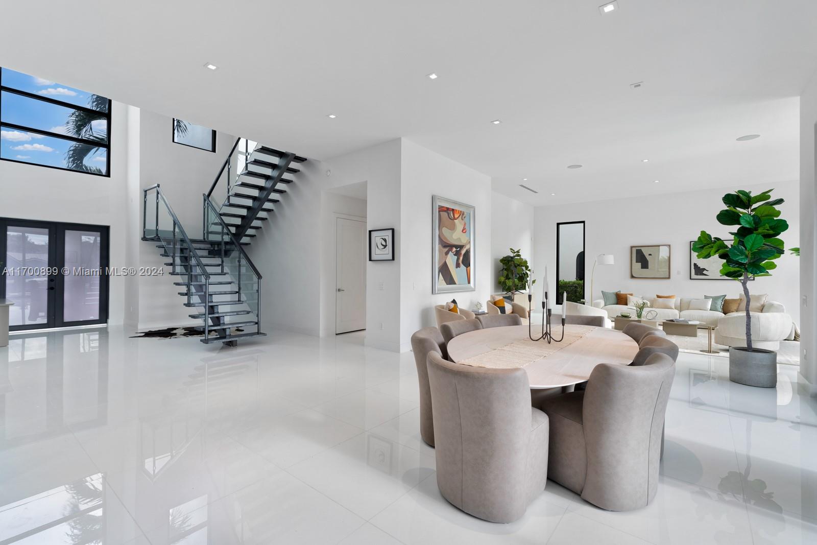 2040 Northeast 121st Road North Miami, FL 33181 - Photo 10 of 43 a dining room with kitchen island furniture and a chandelier