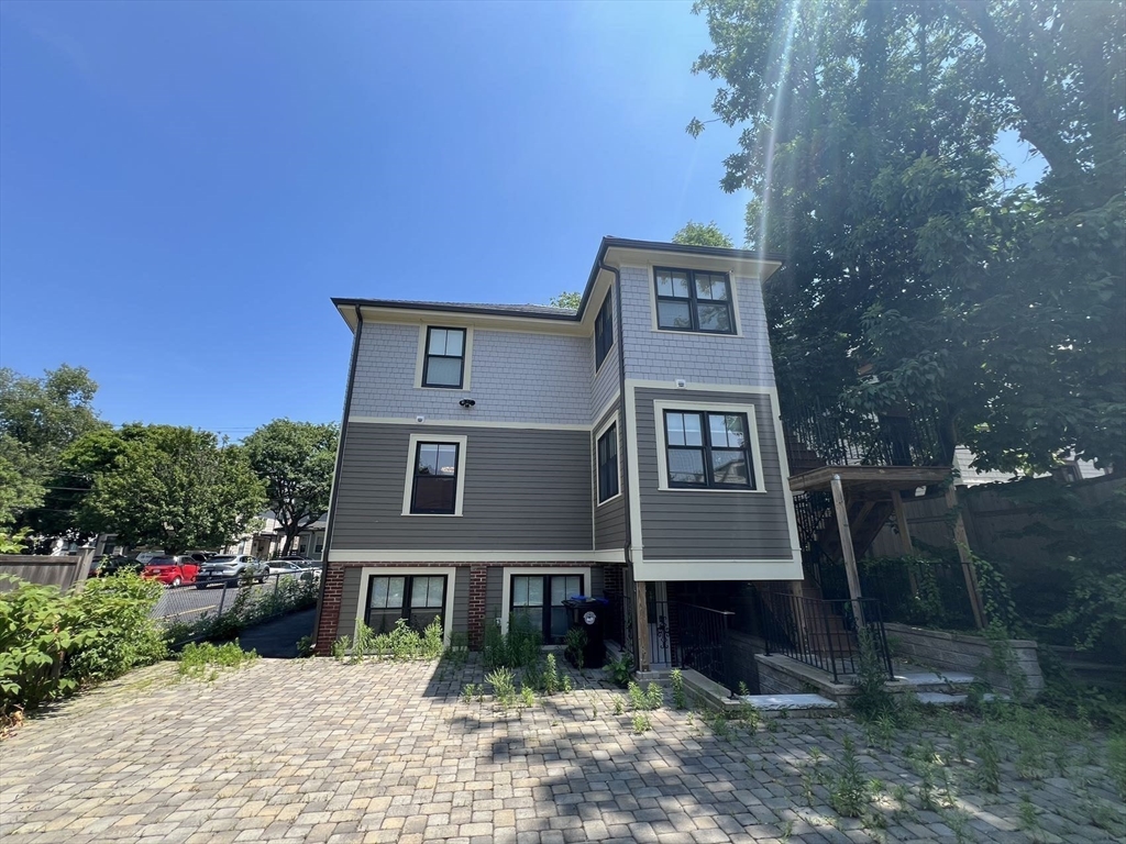23 Winslow Road, Unit 1 Brookline, MA 02446 - Photo 27 of 27 a front view of a house with a yard