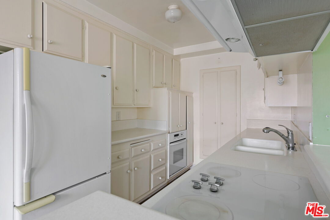 8710 Delgany Avenue, Unit 26 Playa del Rey, CA 90293 - Photo 14 of 25 a bathroom with a granite countertop sink a toilet and shower