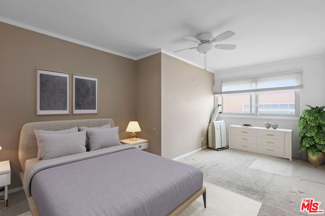 8710 Delgany Avenue, Unit 26 Playa del Rey, CA 90293 - Photo 17 of 25 a bedroom with a bed and a chandelier