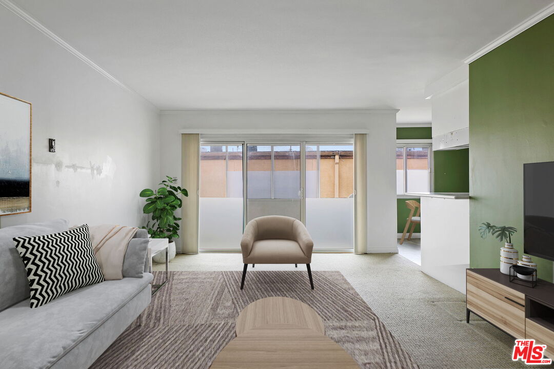 8710 Delgany Avenue, Unit 26 Playa del Rey, CA 90293 - Photo 7 of 25 a living room with furniture and a flat screen tv
