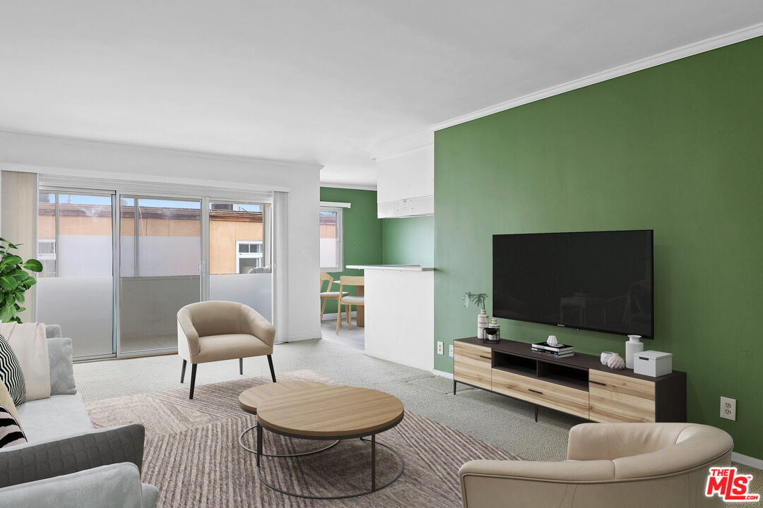 8710 Delgany Avenue, Unit 26 Playa del Rey, CA 90293 - Photo 9 of 25 a living room with furniture and a flat screen tv