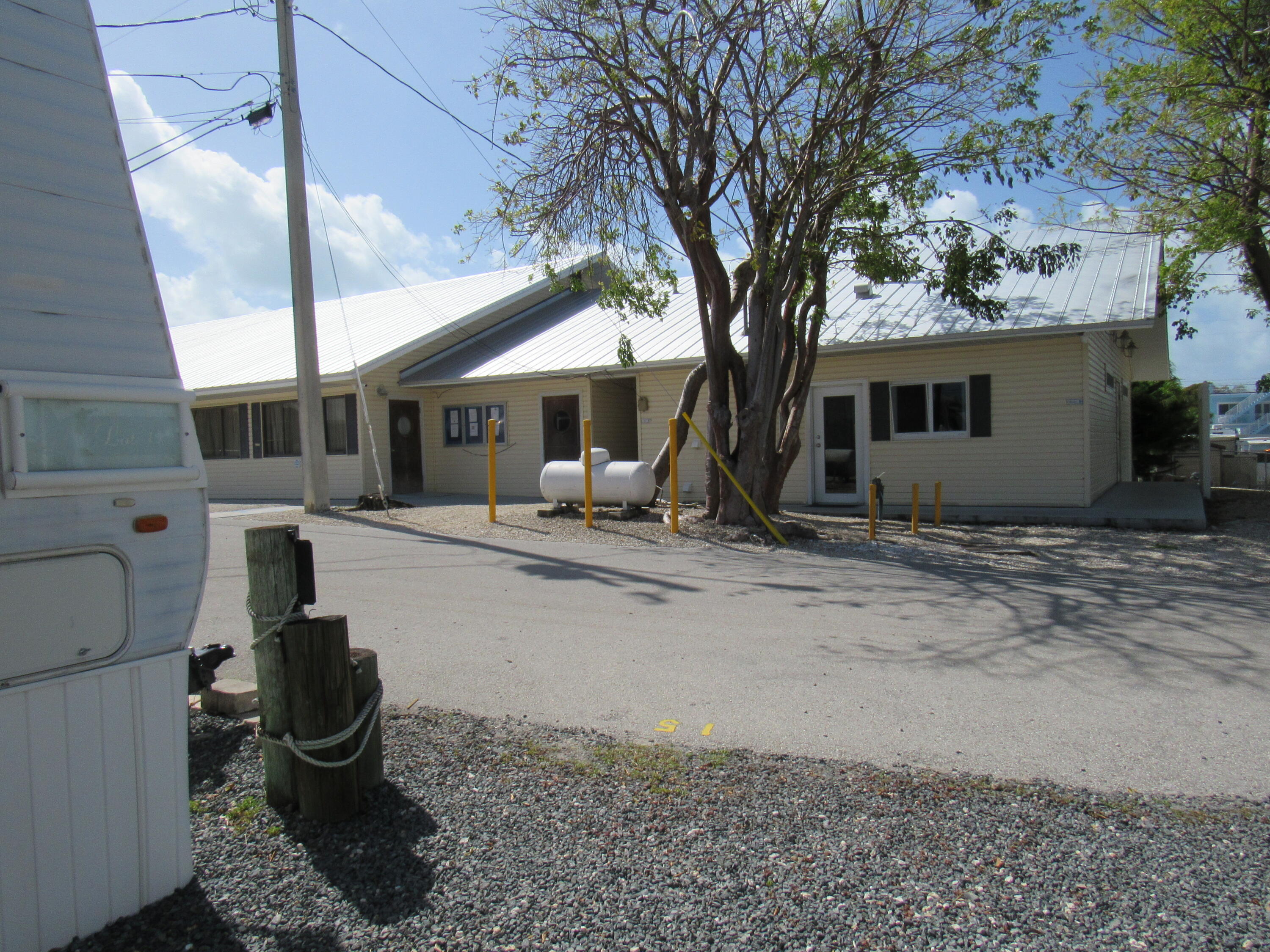 325 Calusa Street, Unit 15 Key Largo, FL 33037 - Photo 14 of 32 a backyard of a house with yard and outdoor seating