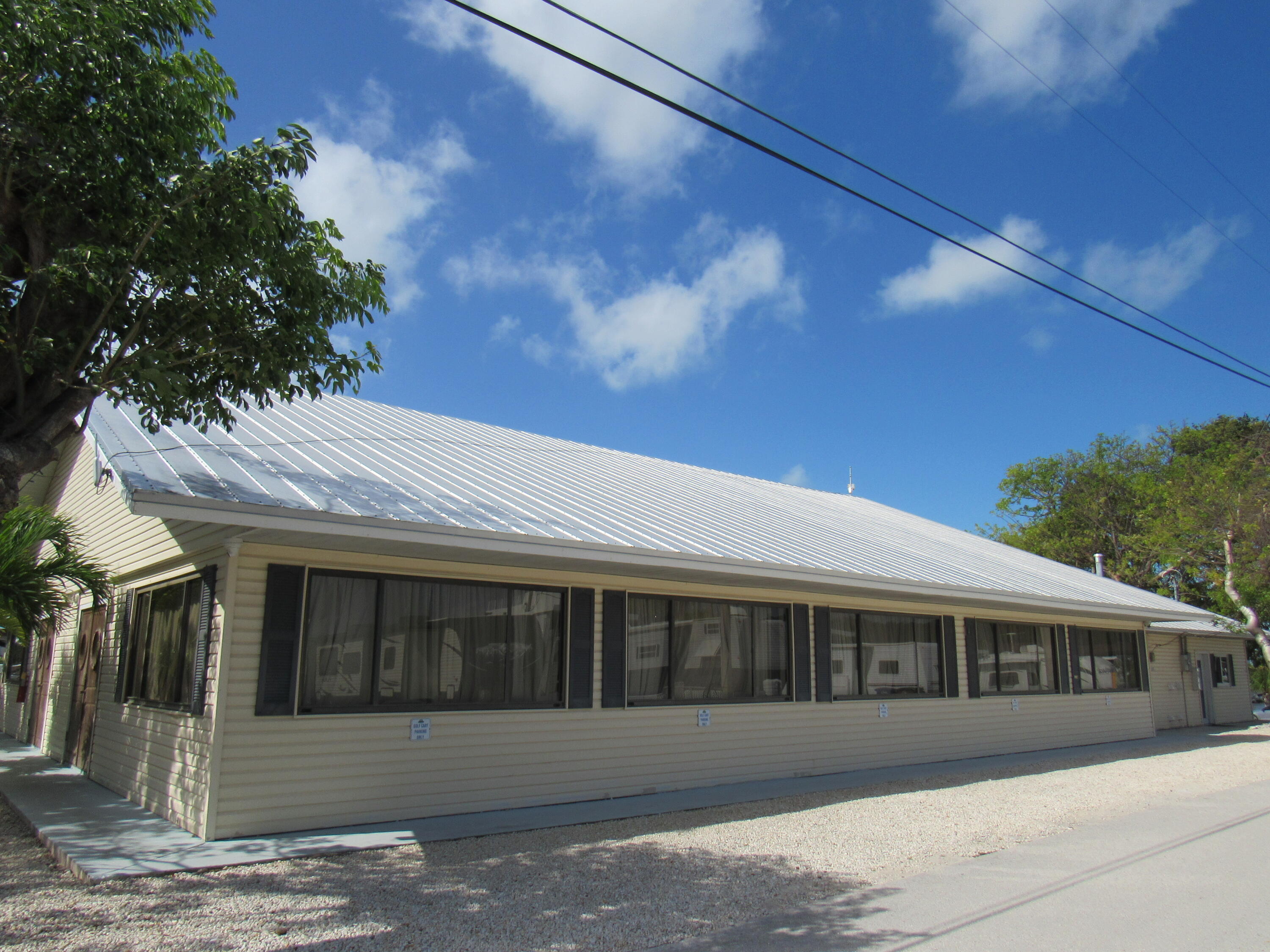 325 Calusa Street, Unit 15 Key Largo, FL 33037 - Photo 15 of 32 a front view of a house with a garden