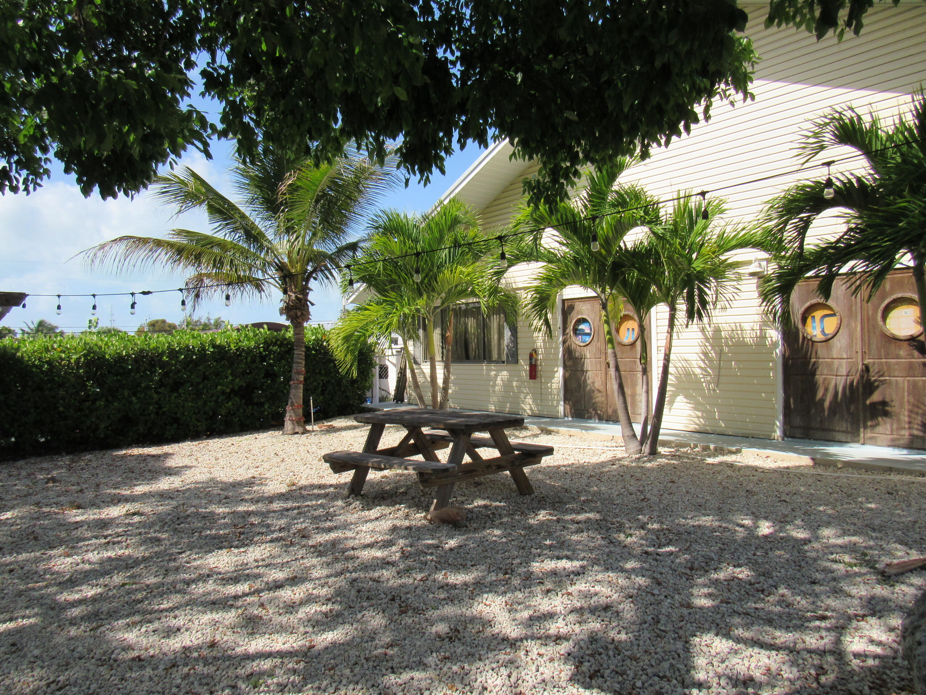 325 Calusa Street, Unit 15 Key Largo, FL 33037 - Photo 16 of 32 a row of palm trees in front of house