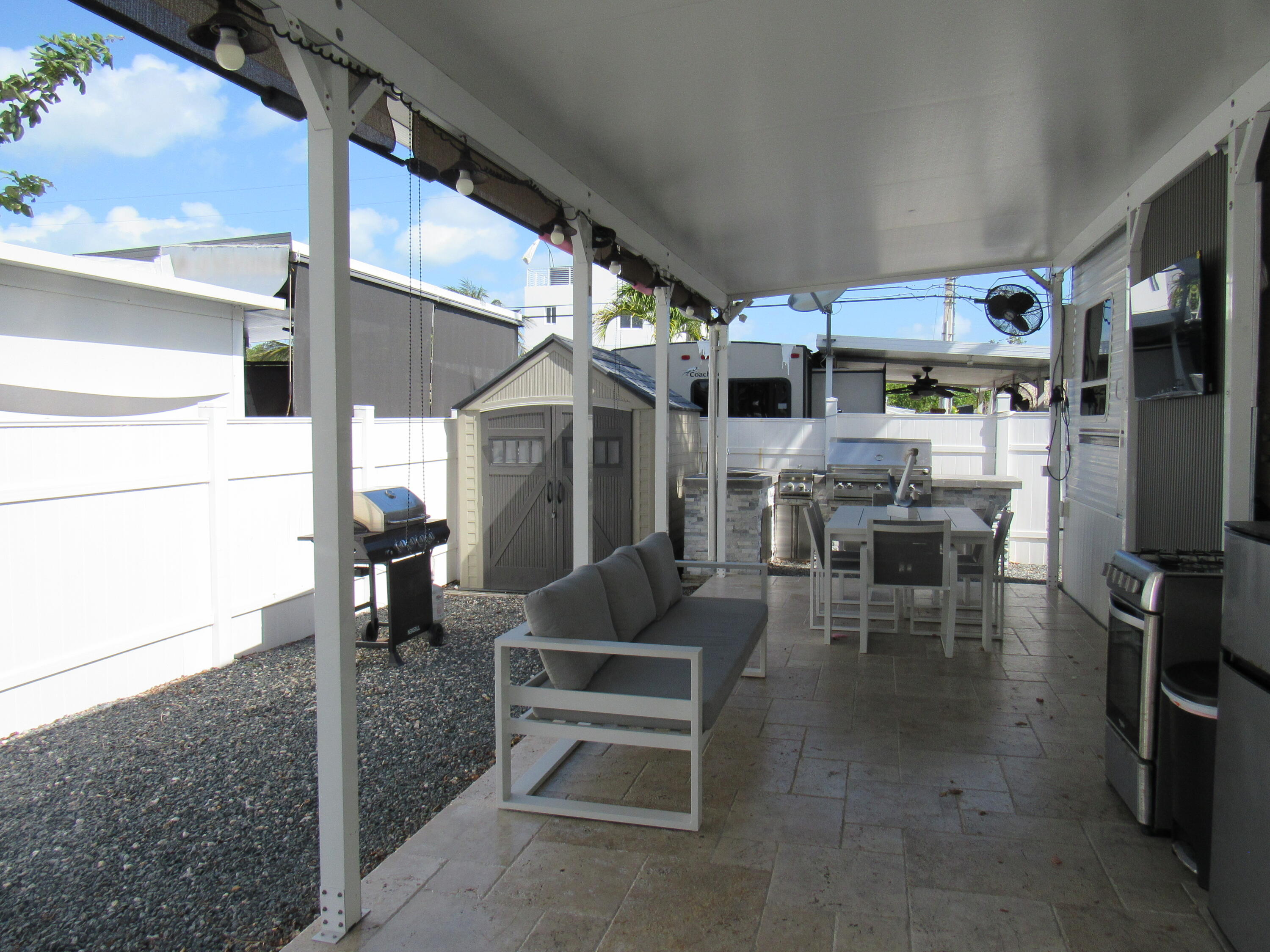 325 Calusa Street, Unit 15 Key Largo, FL 33037 - Photo 2 of 32 a outdoor space with lots of tables a chairs and potted plants