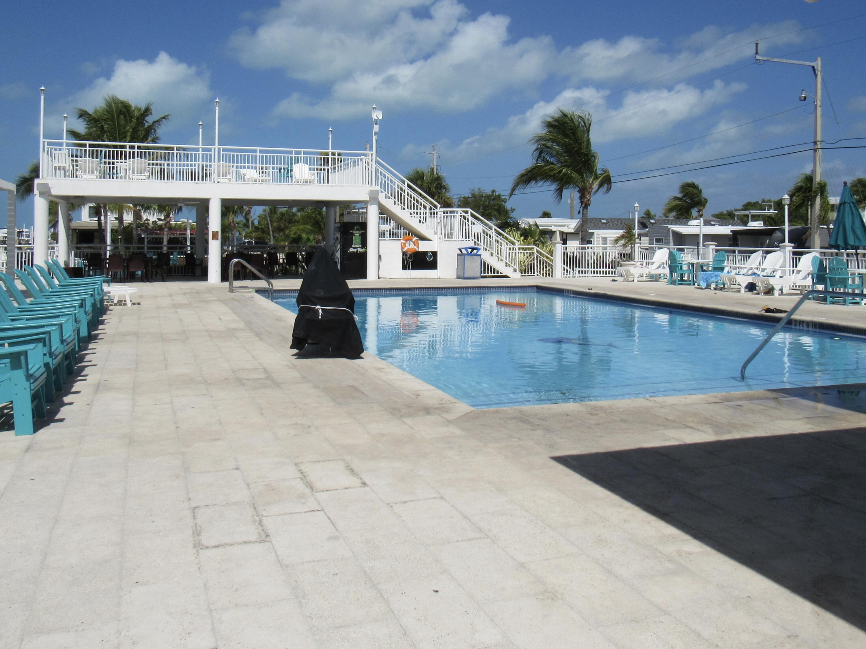 325 Calusa Street, Unit 15 Key Largo, FL 33037 - Photo 24 of 32 a view of a swimming pool with a patio