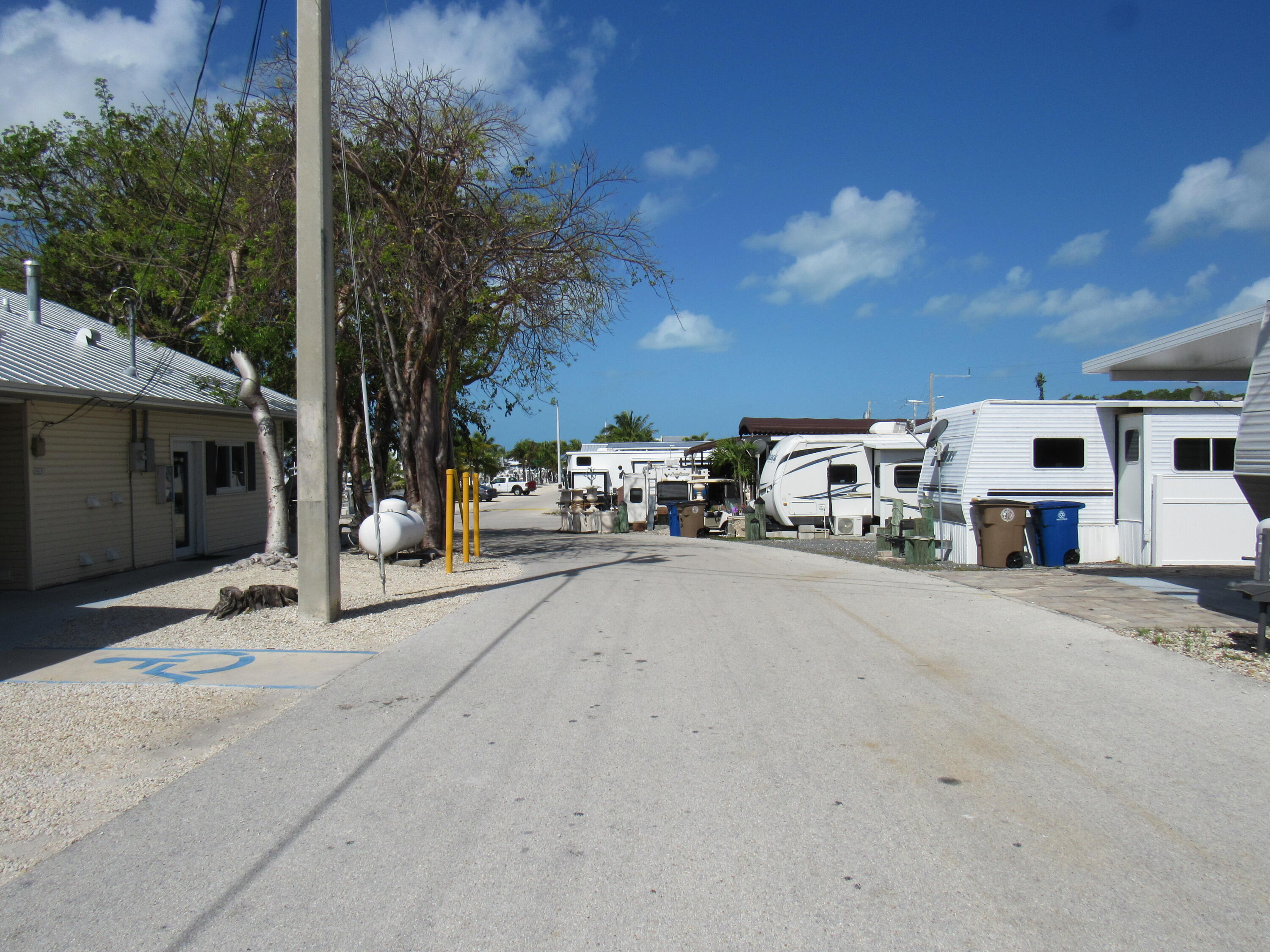 325 Calusa Street, Unit 15 Key Largo, FL 33037 - Photo 26 of 32 a building with trees in front of it