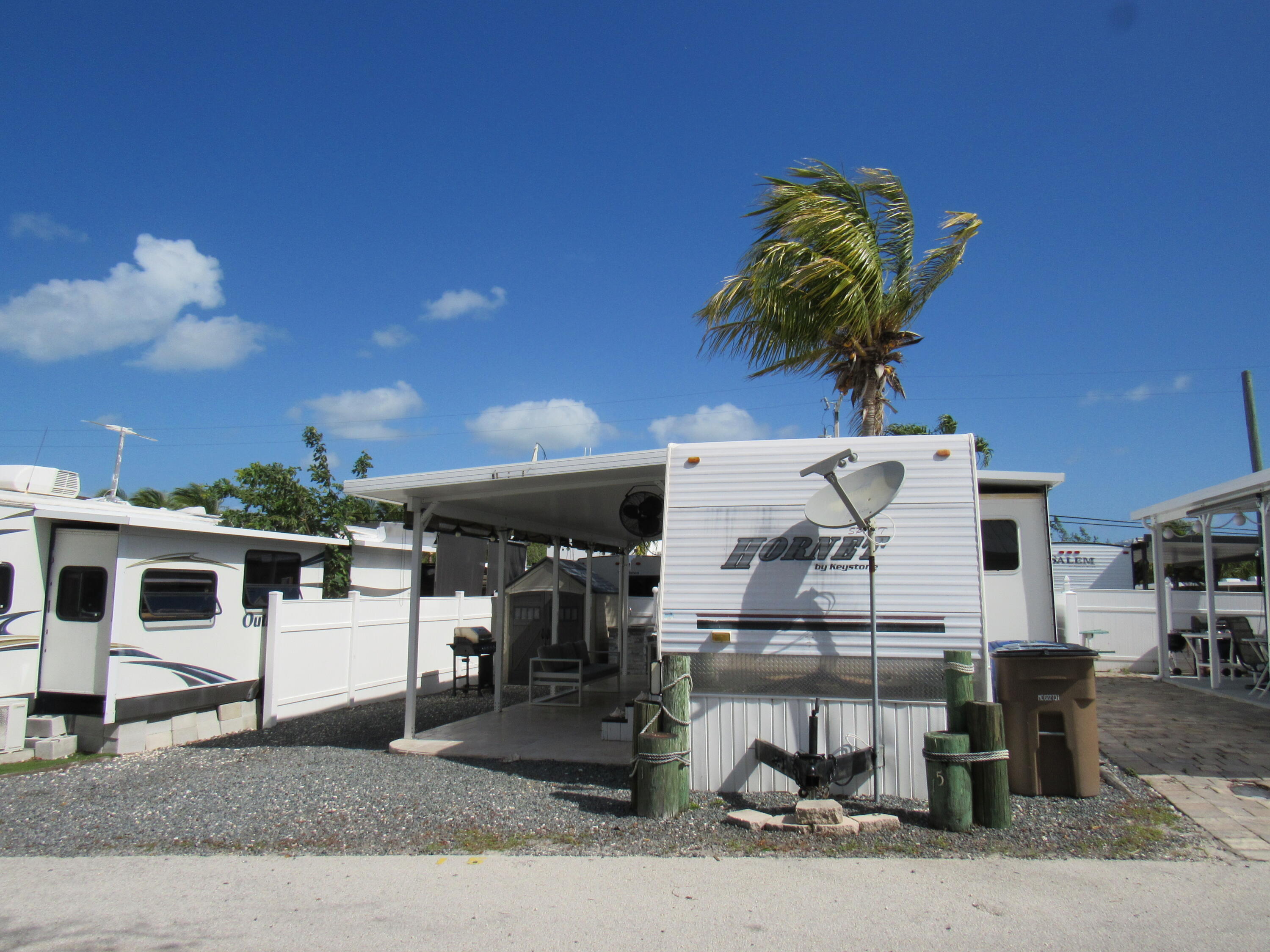 325 Calusa Street, Unit 15 Key Largo, FL 33037 - Photo 29 of 32 a front view of a house with garden