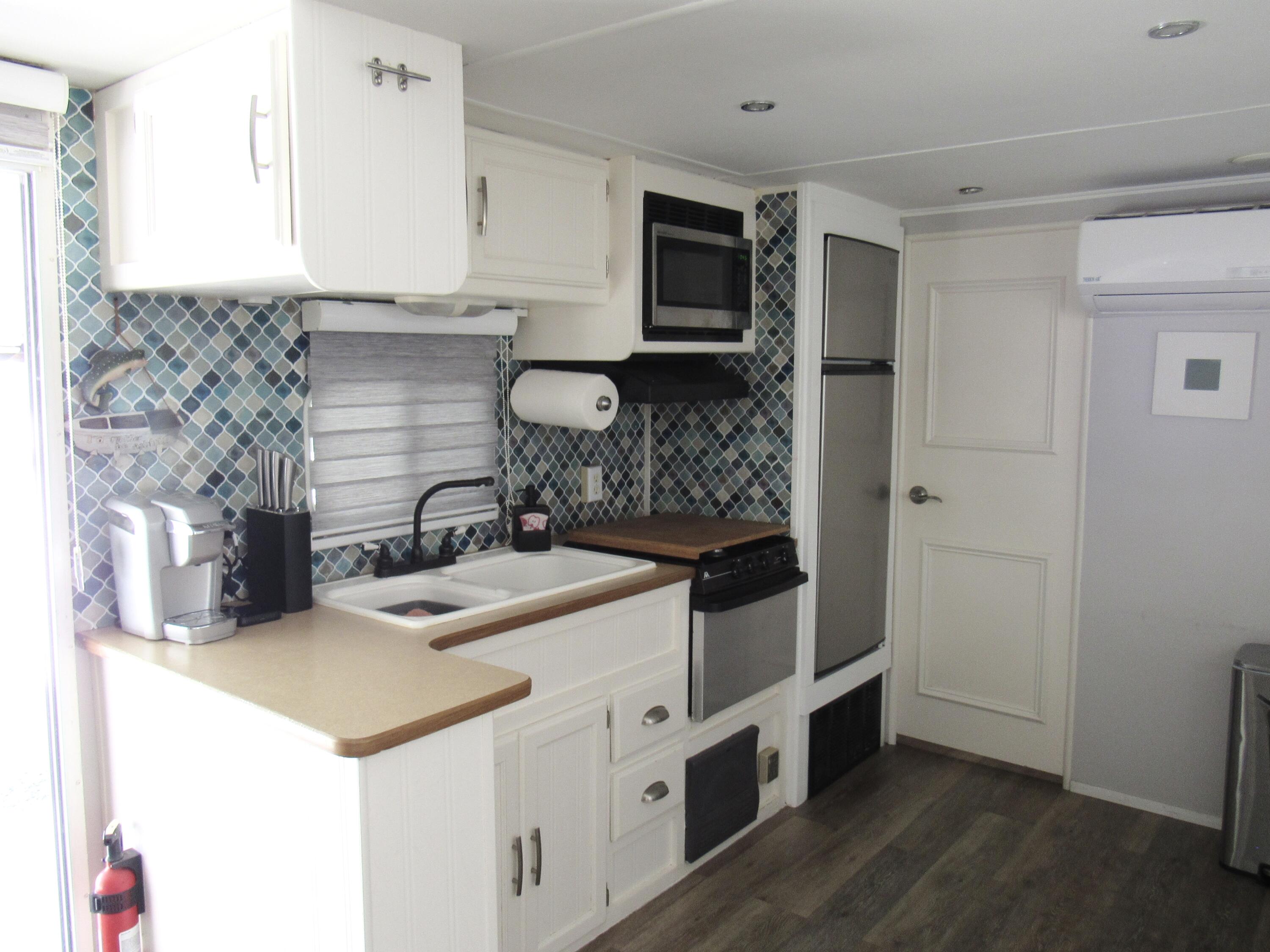 325 Calusa Street, Unit 15 Key Largo, FL 33037 - Photo 3 of 32 a kitchen with a sink and cabinets