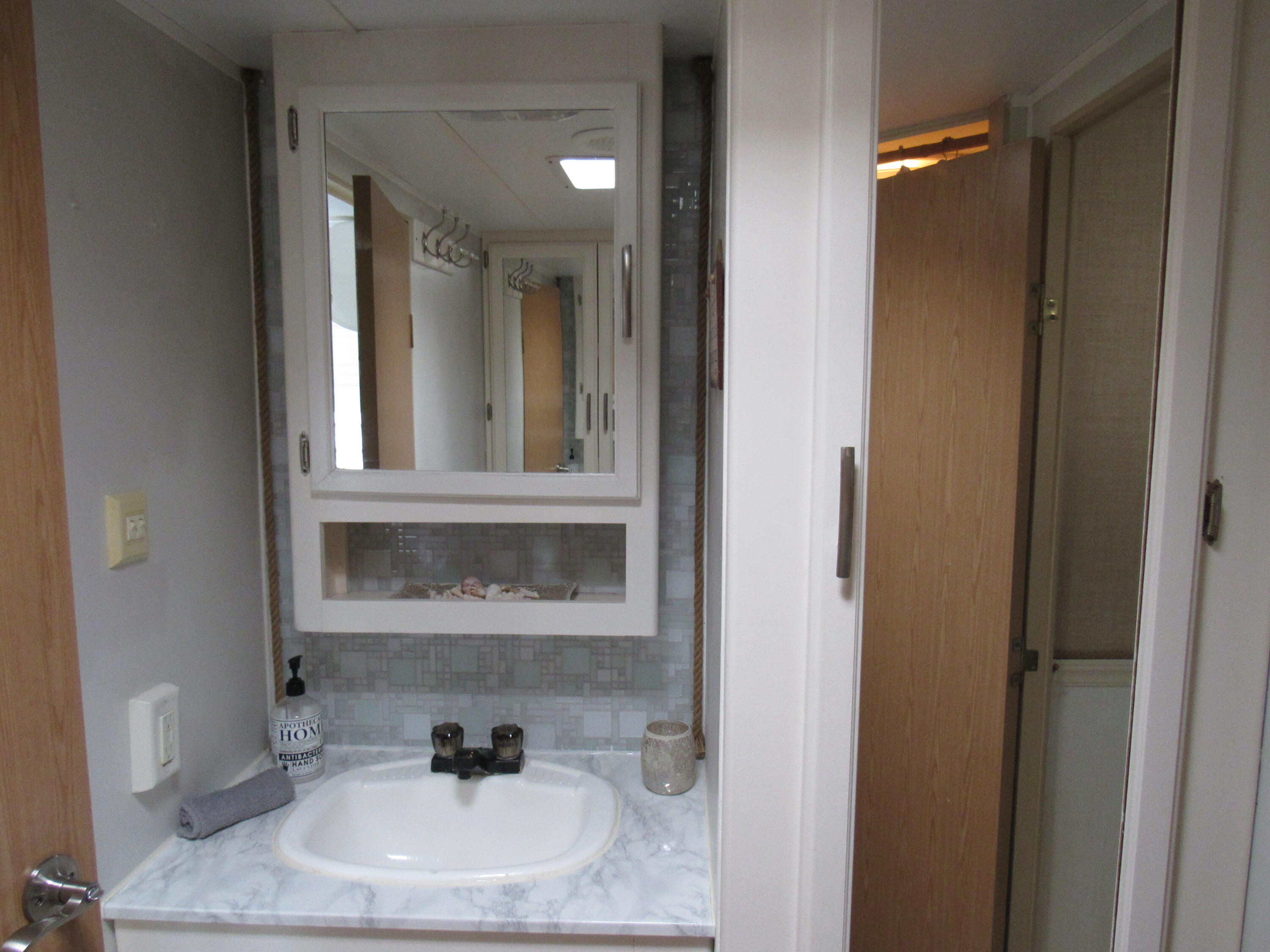 325 Calusa Street, Unit 15 Key Largo, FL 33037 - Photo 8 of 32 a bathroom with a sink and a mirror