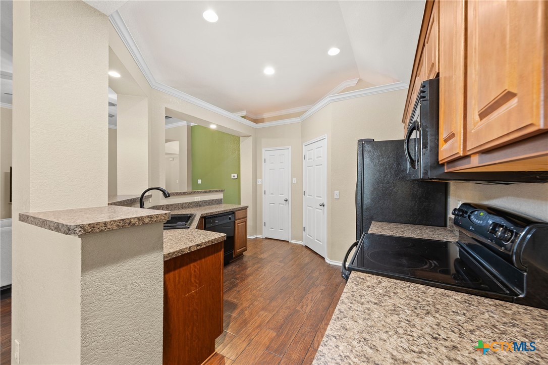 910 Neuberry Cliffe Temple, TX 76502 - Photo 10 of 32 a kitchen with stainless steel appliances granite countertop a sink stove and cabinets
