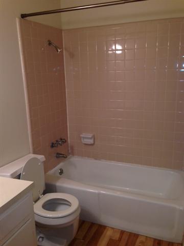 5001 Bull Creek Road, Unit 111 Austin, TX 78731 - Photo 8 of 11 A full bathroom offers a classic tub and shower combination with light-colored tile.