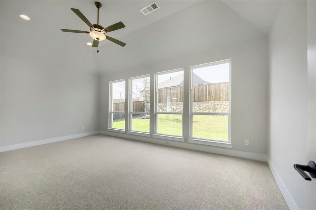 800 Blackberry Road Haslet, TX 76052 - Photo 13 of 28 Room featuring a vaulted ceiling with a ceiling fan, recessed lighting, and light-colored carpeting