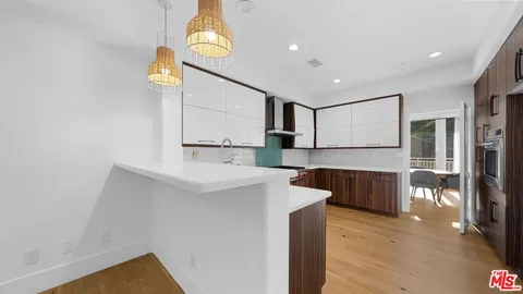 a kitchen with stainless steel appliances a refrigerator and a stove top oven