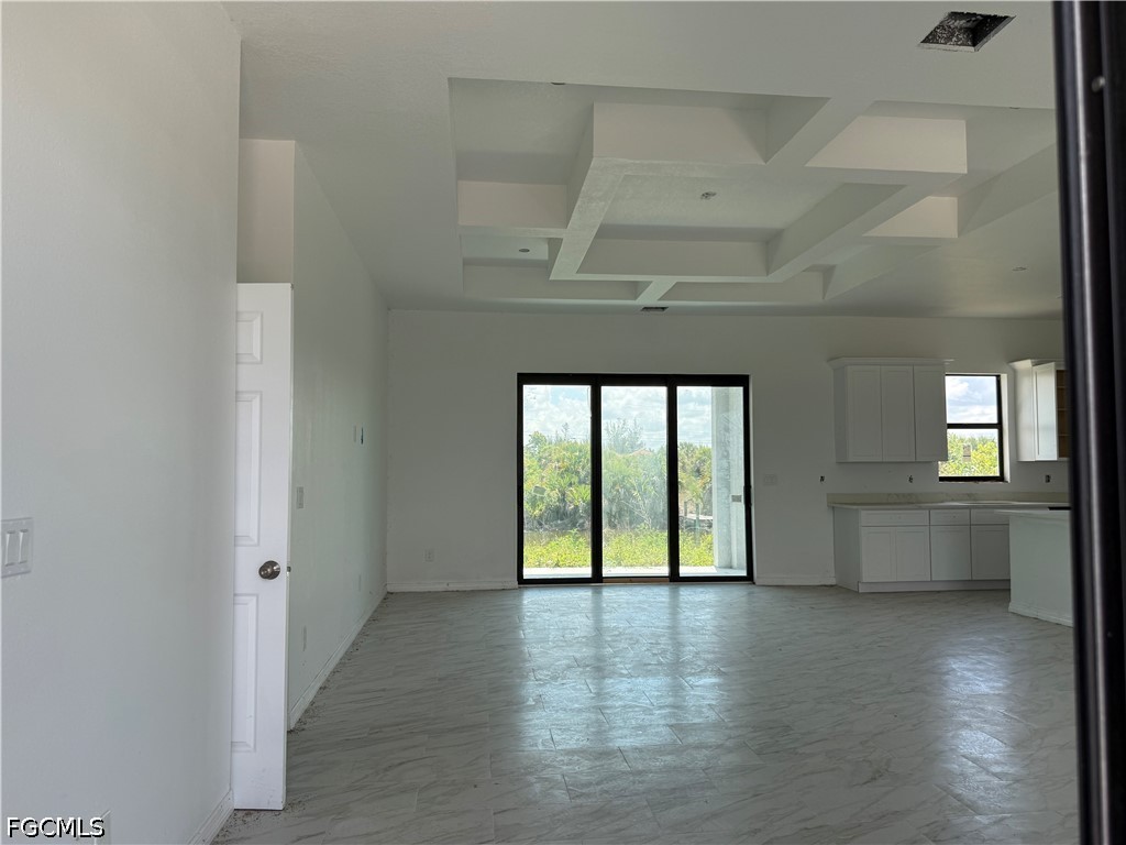 10658 Rainsville Street Port Charlotte, FL 33981 - Photo 2 of 21 an empty room with wooden floor and windows