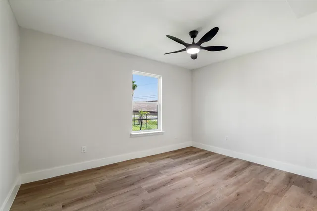 wooden floor in an empty room with a window