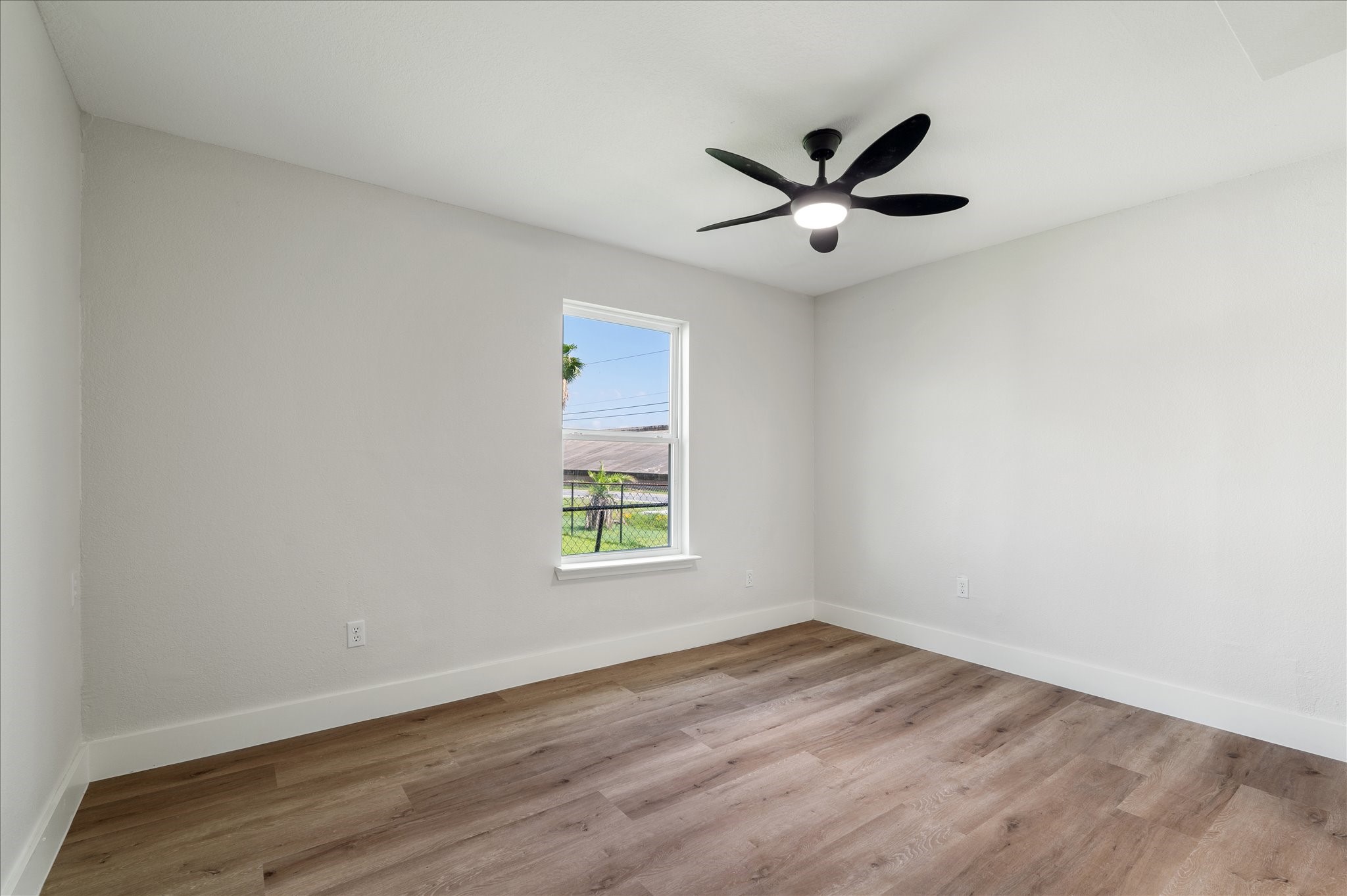 7104 Dallas Street, Unit 1 Baytown, TX 77521 - Photo 11 of 17 wooden floor in an empty room with a window