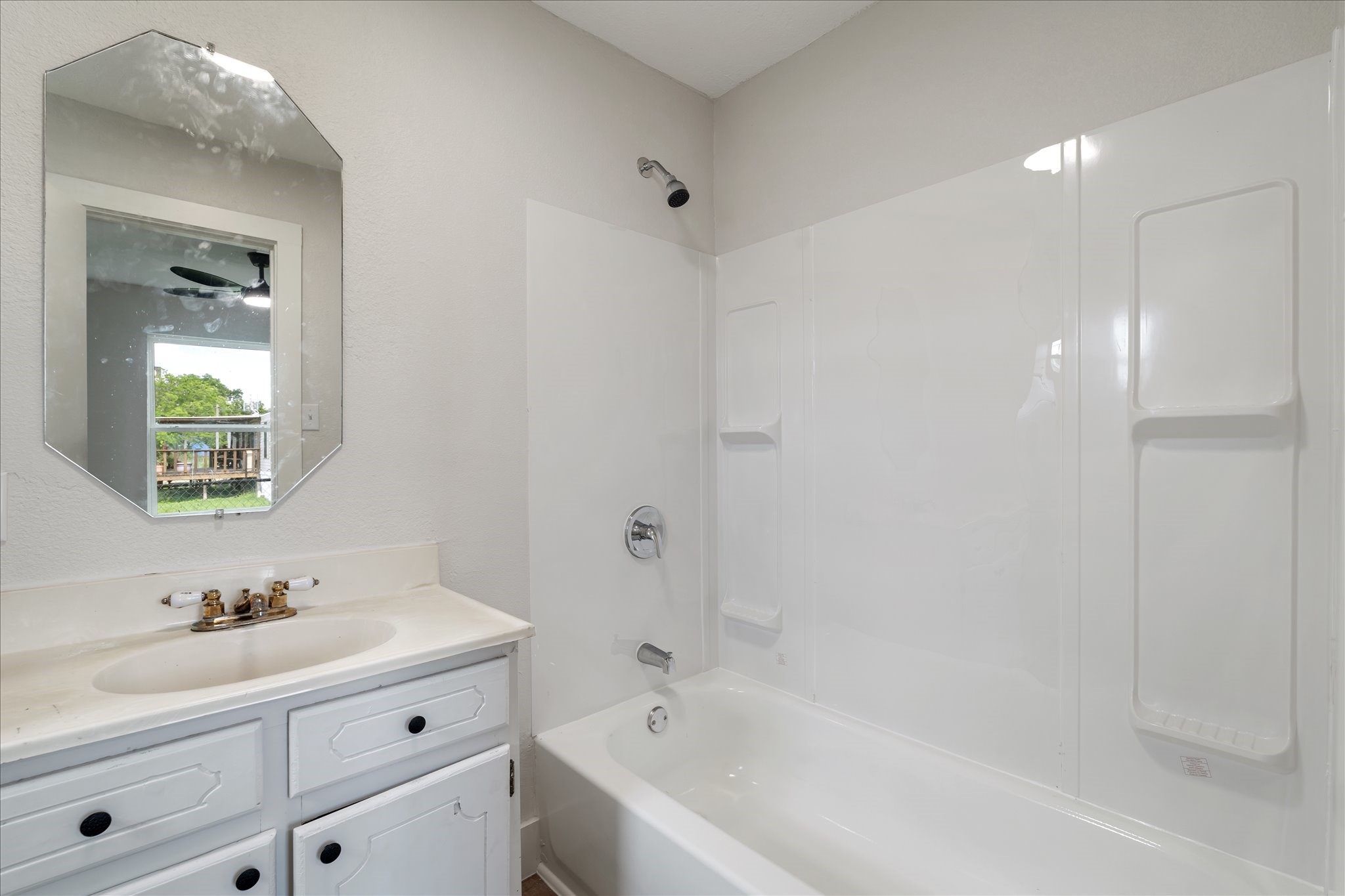 7104 Dallas Street, Unit 1 Baytown, TX 77521 - Photo 13 of 17 a bathroom with a bathtub shower sink vanity and mirror