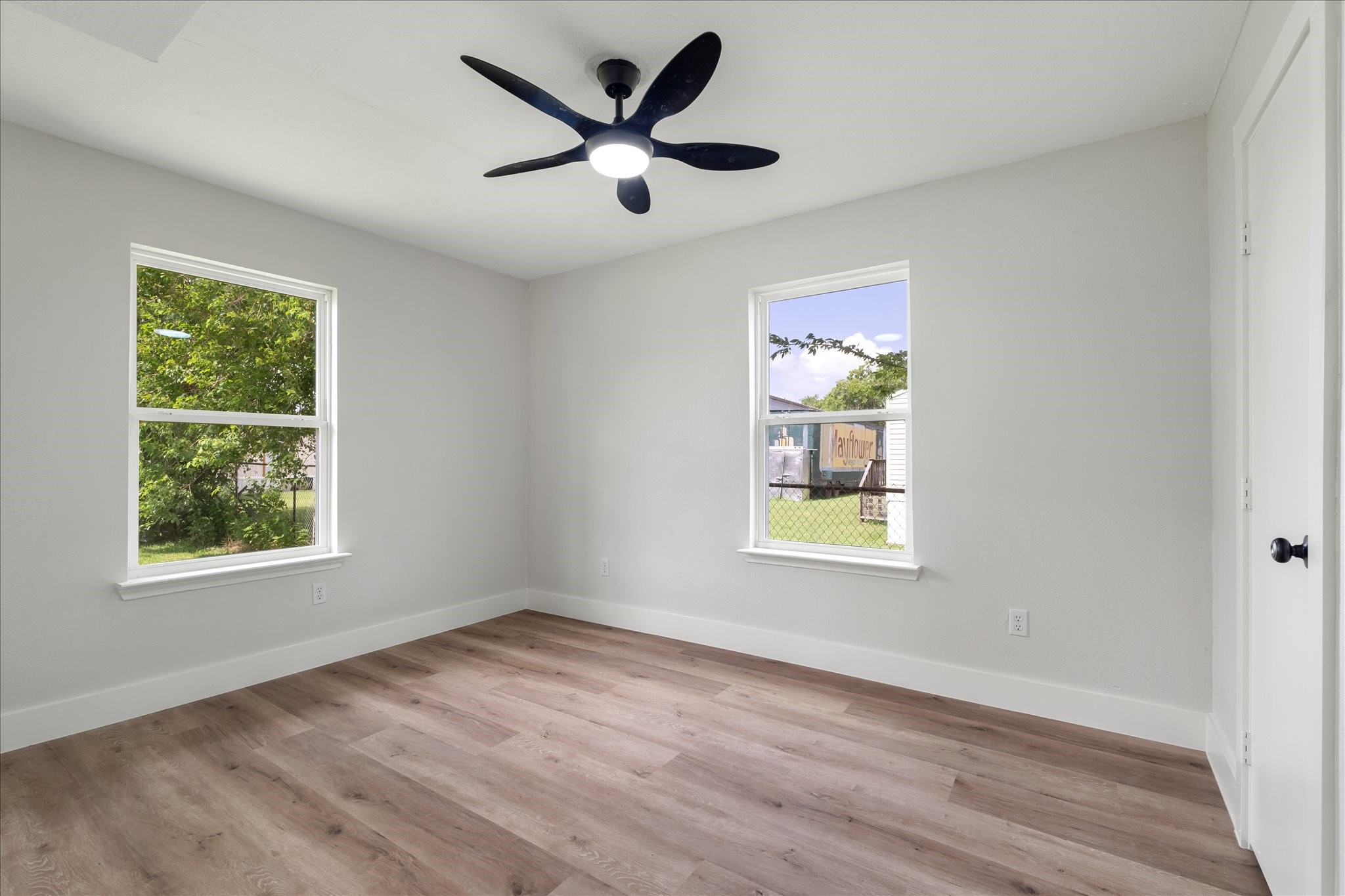 7104 Dallas Street, Unit 1 Baytown, TX 77521 - Photo 14 of 17 an empty room with wooden floor and windows
