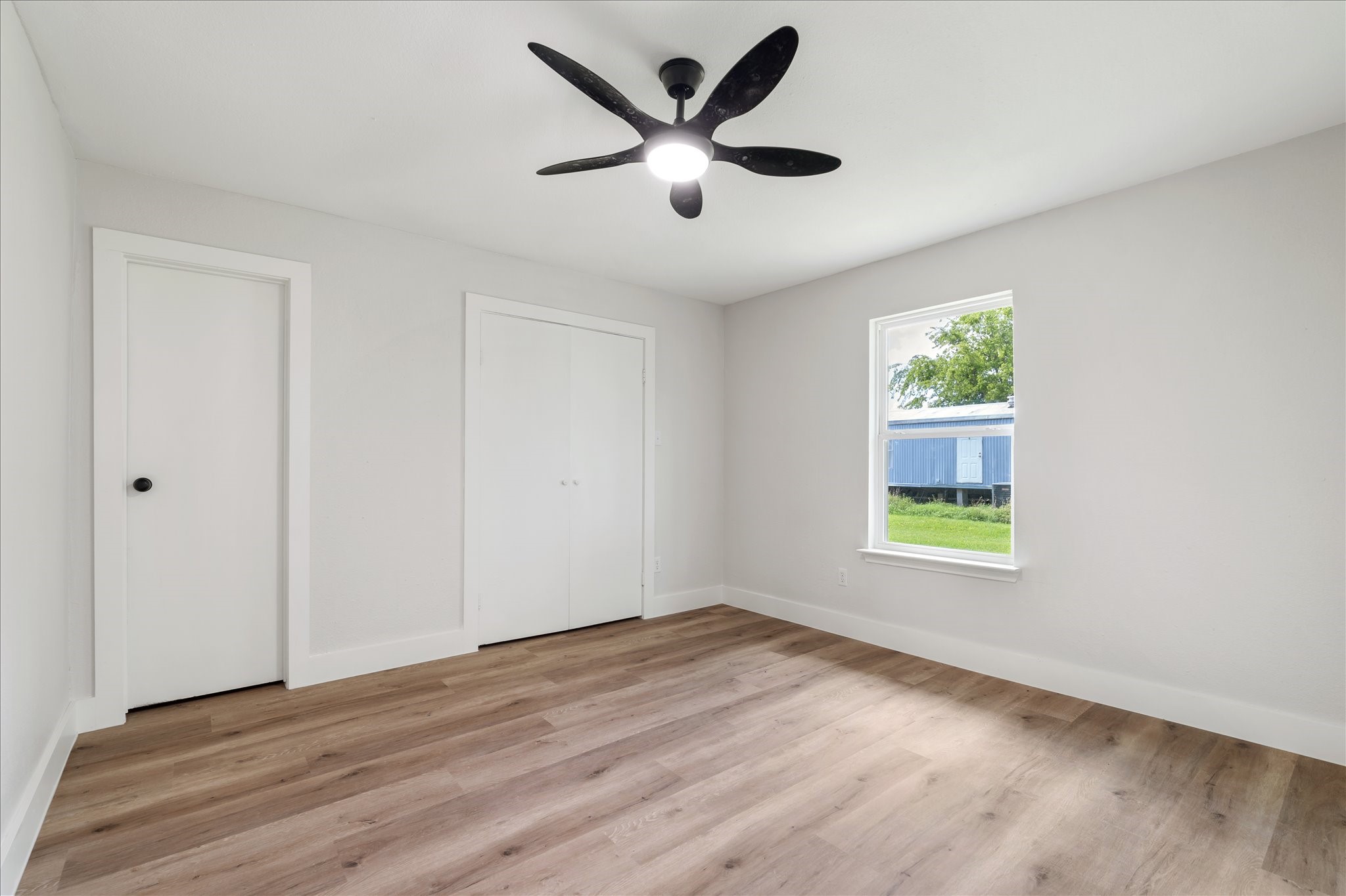 7104 Dallas Street, Unit 1 Baytown, TX 77521 - Photo 16 of 17 wooden floor in an empty room with a window