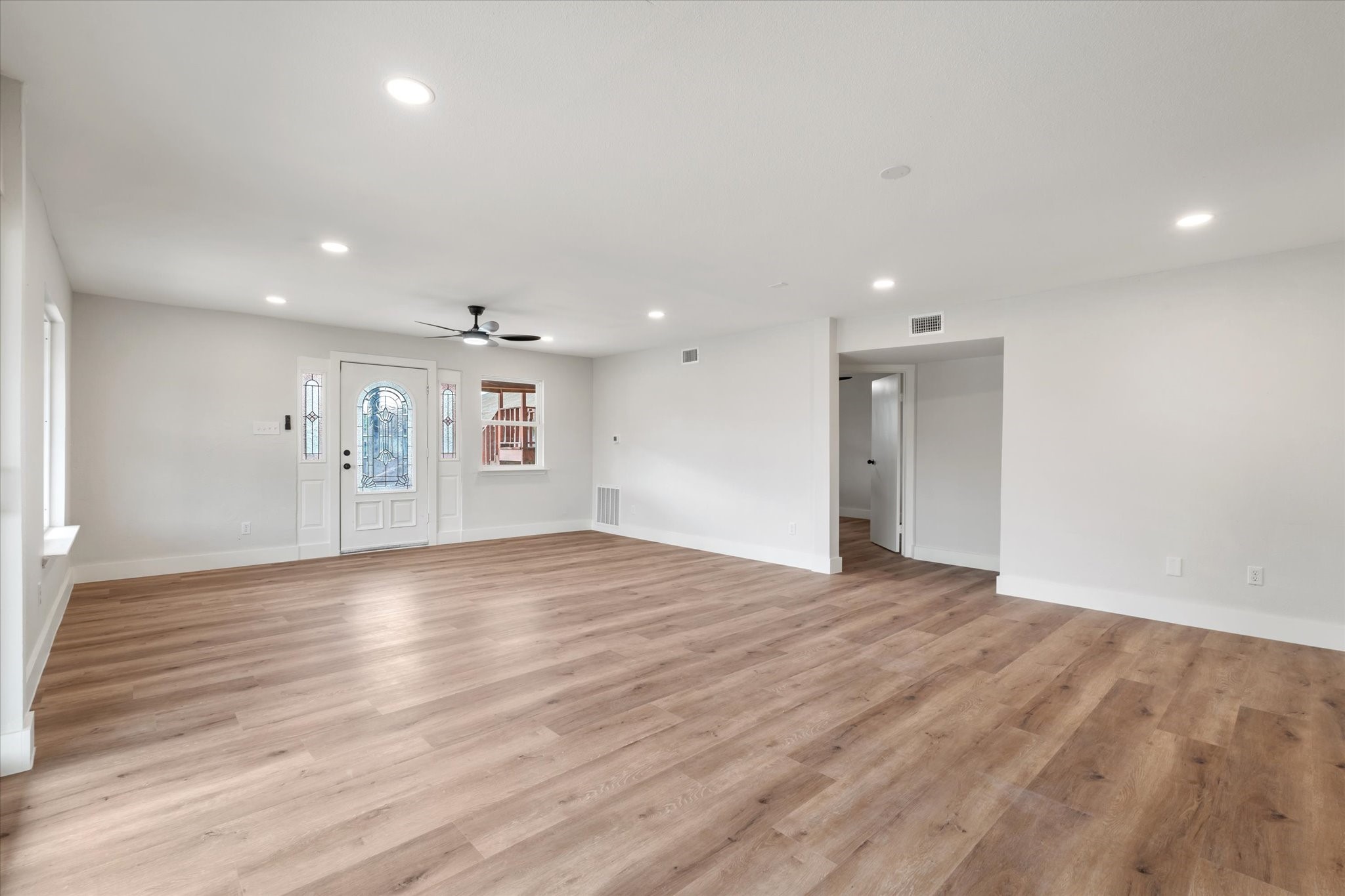 7104 Dallas Street, Unit 1 Baytown, TX 77521 - Photo 2 of 17 a view of an empty room with wooden floor and a window