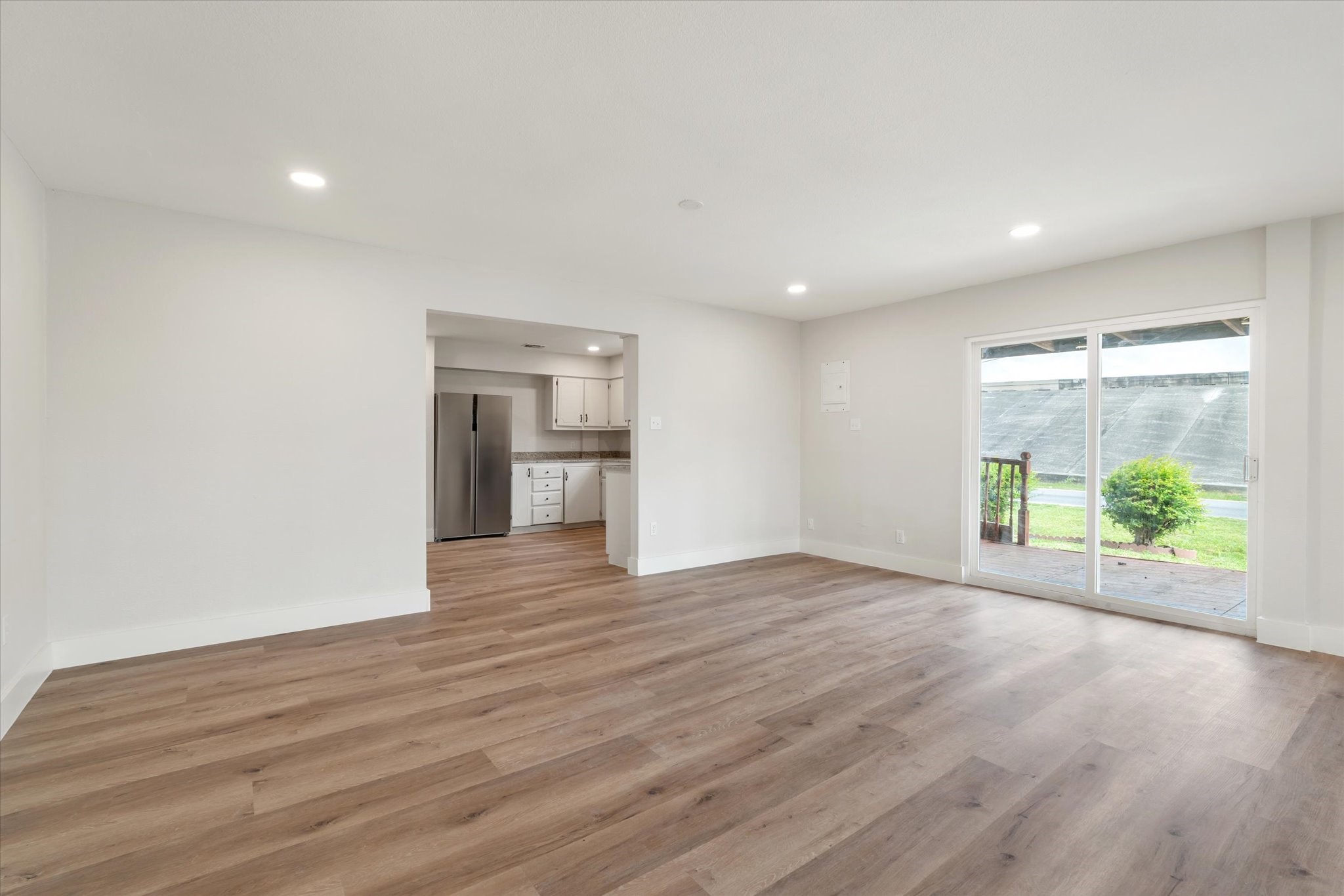 7104 Dallas Street, Unit 1 Baytown, TX 77521 - Photo 3 of 17 a view of an empty room with wooden floor and a window