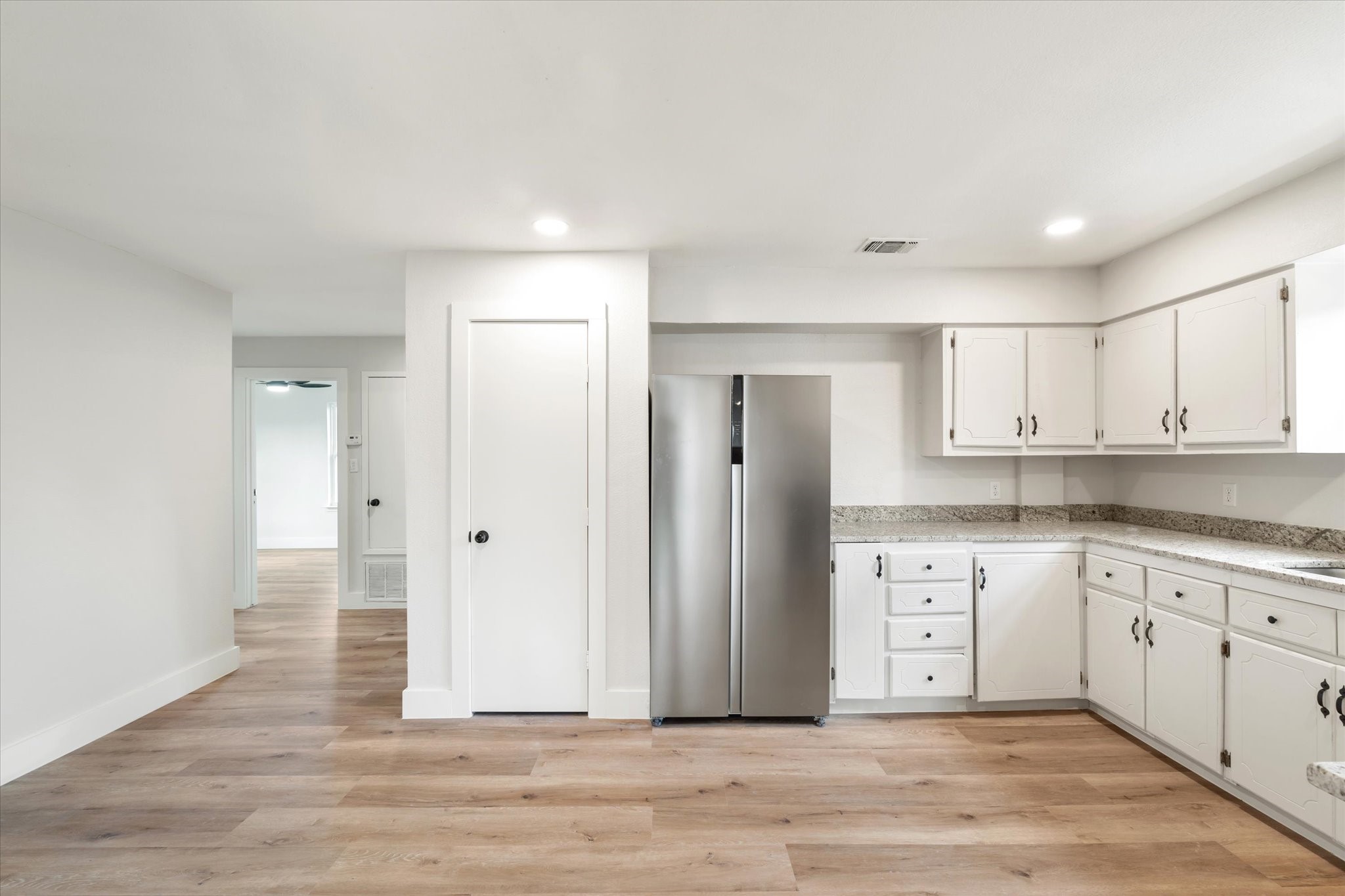 7104 Dallas Street, Unit 1 Baytown, TX 77521 - Photo 4 of 17 a view of a kitchen with granite countertop cabinets and wooden floor
