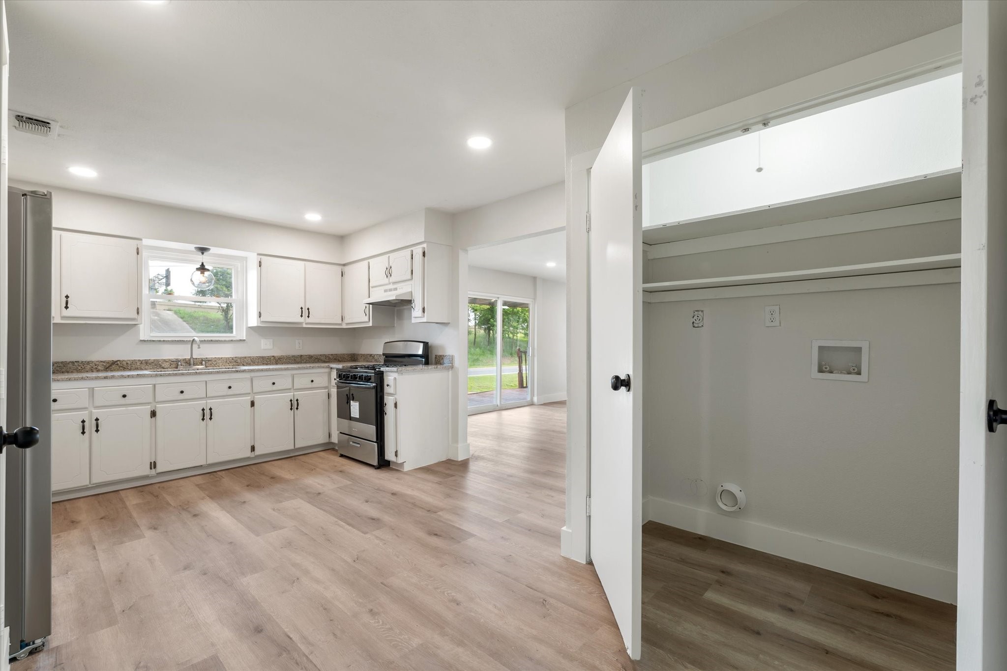 7104 Dallas Street, Unit 1 Baytown, TX 77521 - Photo 7 of 17 a kitchen with stainless steel appliances granite countertop a refrigerator and a stove