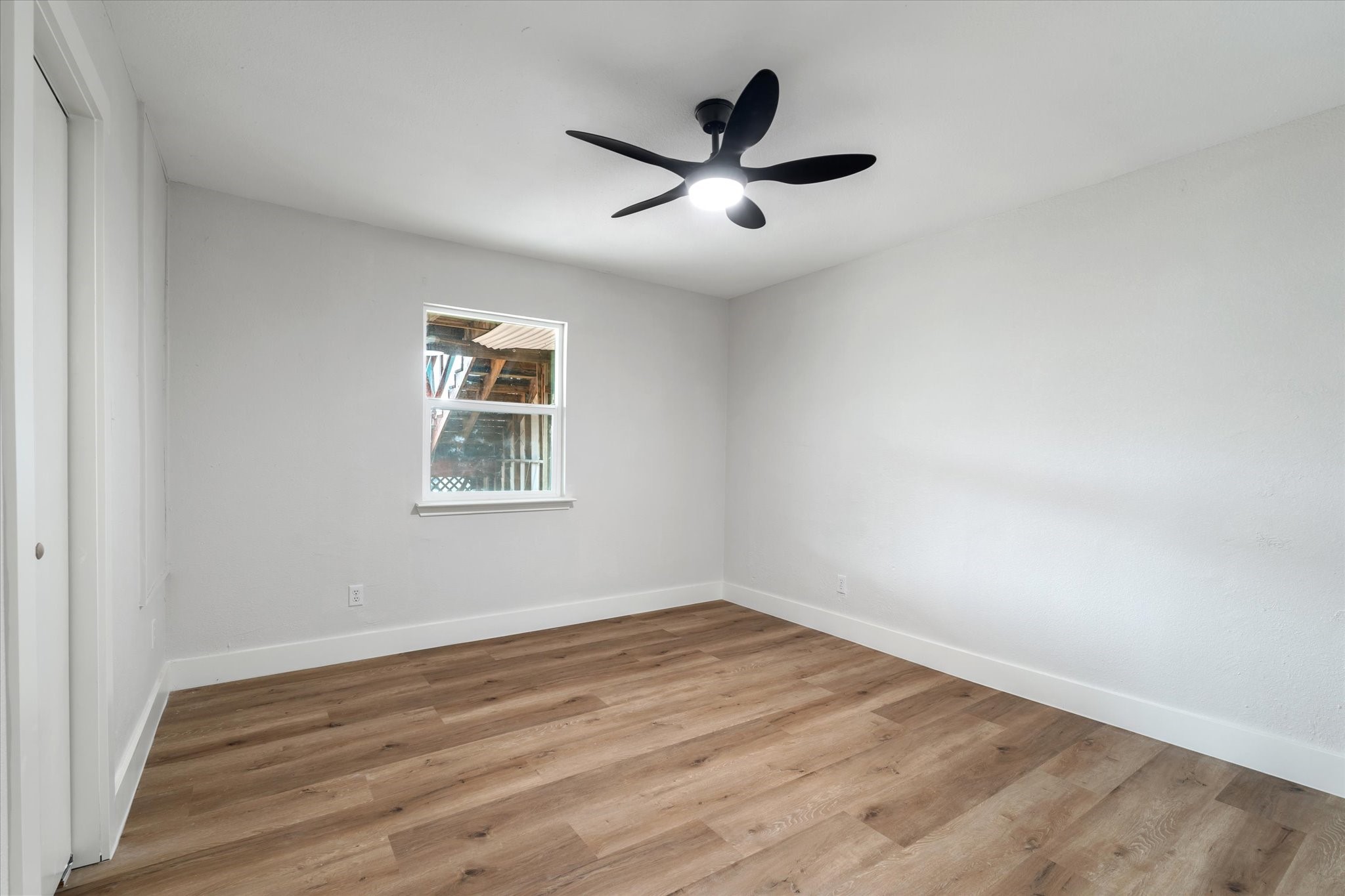 7104 Dallas Street, Unit 1 Baytown, TX 77521 - Photo 8 of 17 a view of a big room with wooden floor and windows