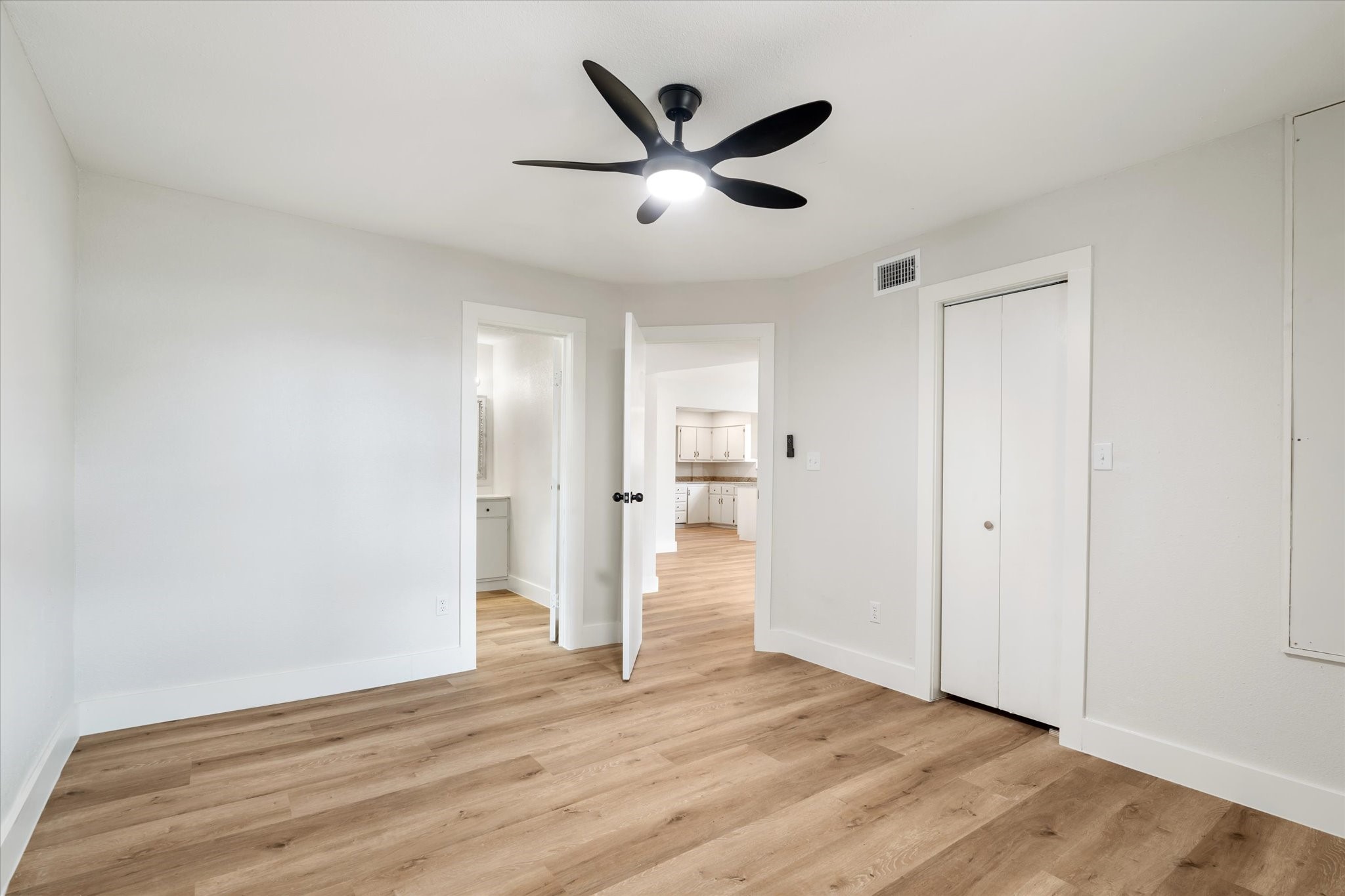 7104 Dallas Street, Unit 1 Baytown, TX 77521 - Photo 9 of 17 a view of empty room with wooden floor and ceiling fan