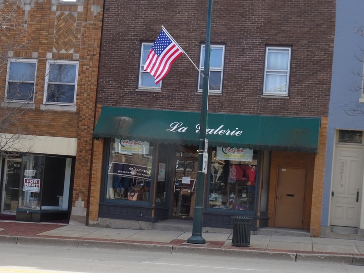 a view of a brick building with a building and a entrance door