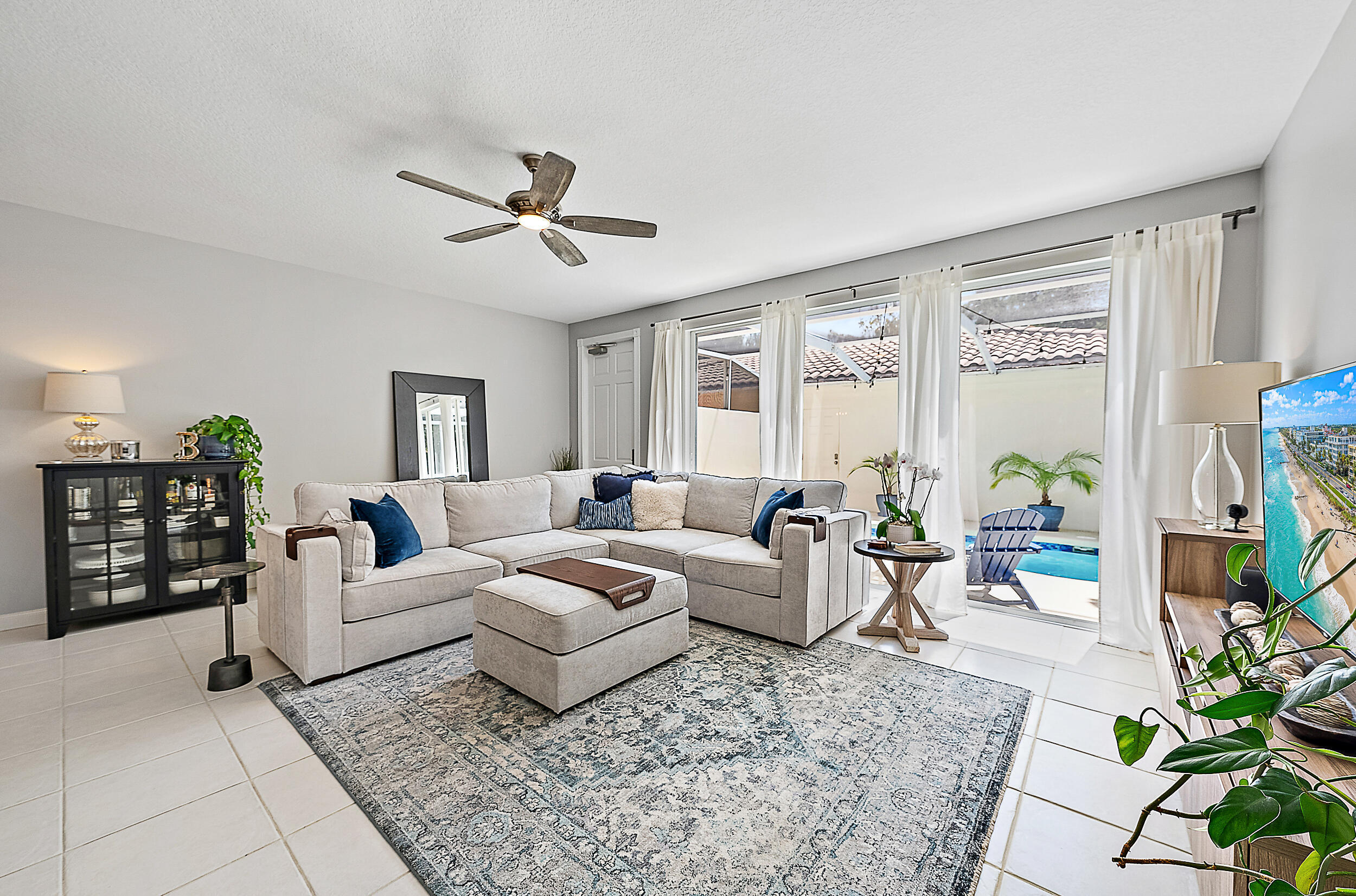 107 Rivinia Drive Jupiter, FL 33458 - Photo 3 of 28 a living room with furniture ceiling fan and a rug