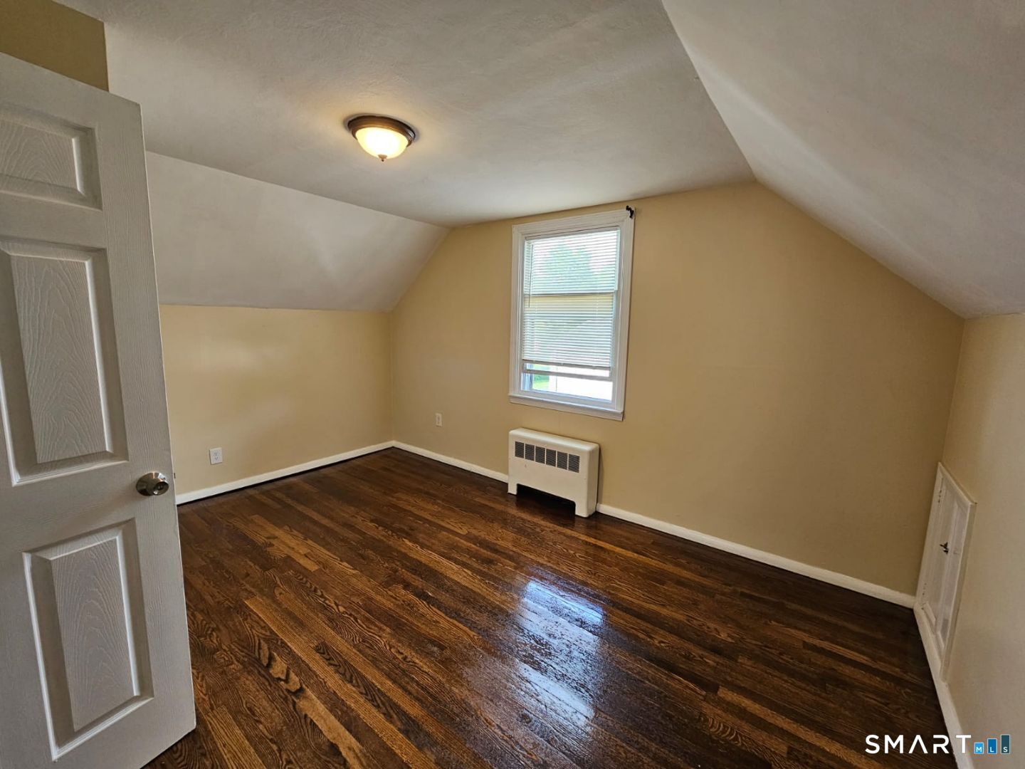 98 East Burnham Street Bloomfield, CT 06002 - Photo 13 of 18 an empty room with wooden floor and windows