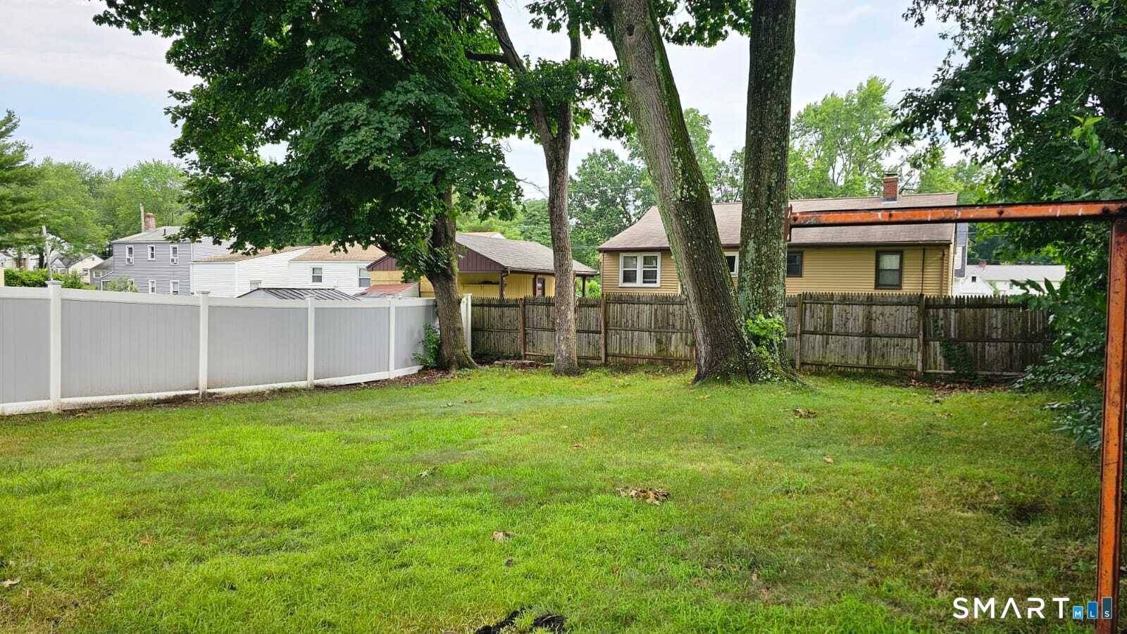 98 East Burnham Street Bloomfield, CT 06002 - Photo 18 of 18 a backyard of a house with lots of green space