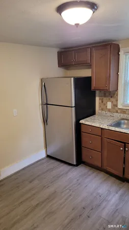 a kitchen with a refrigerator sink and cabinets