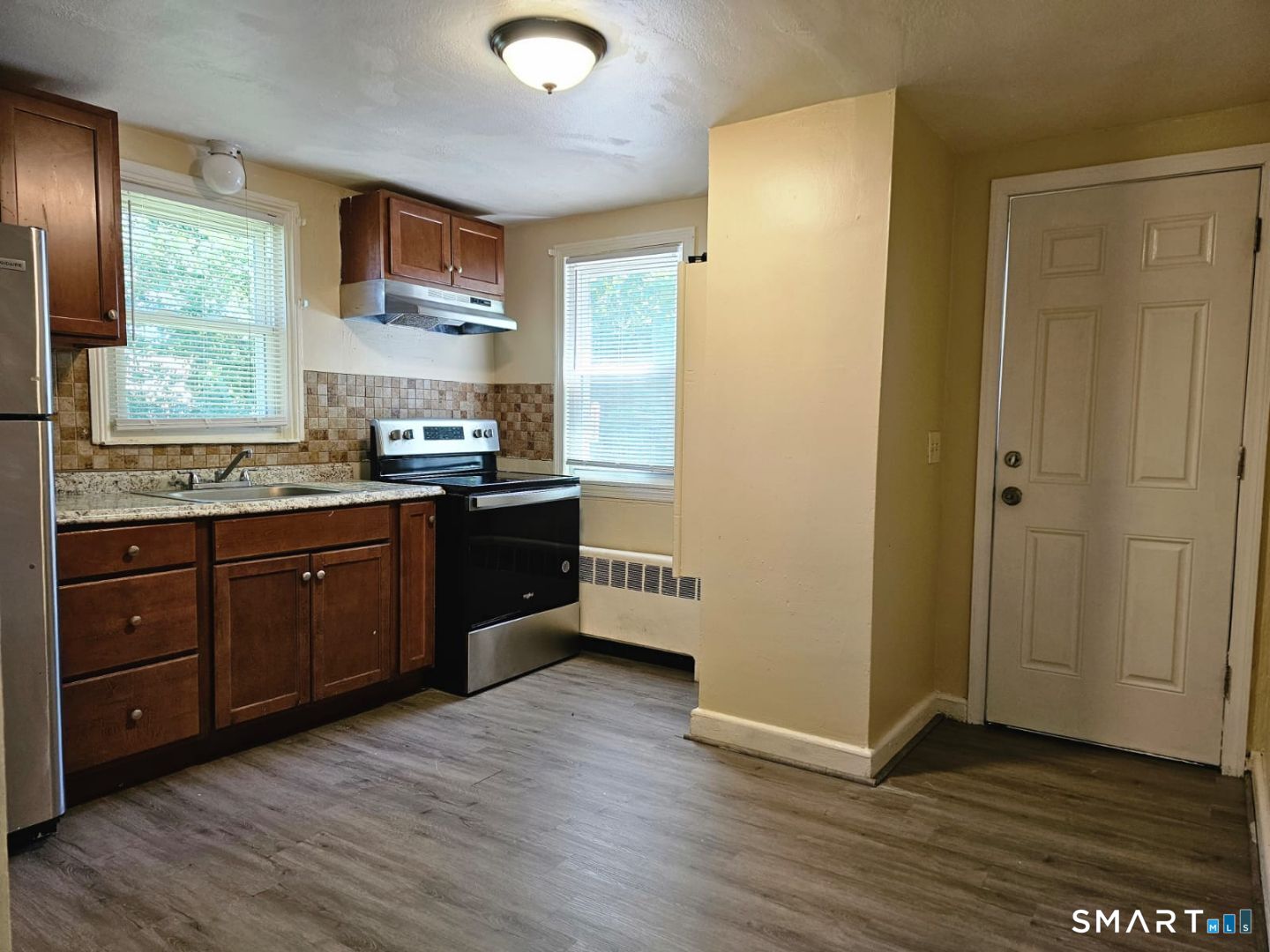 98 East Burnham Street Bloomfield, CT 06002 - Photo 5 of 18 a kitchen with stainless steel appliances granite countertop a stove a sink and a refrigerator