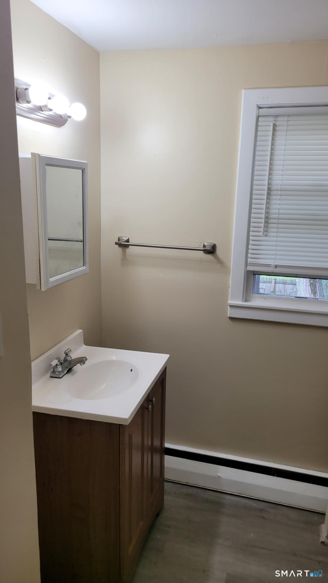 98 East Burnham Street Bloomfield, CT 06002 - Photo 6 of 18 a bathroom with a sink a mirror and a toilet