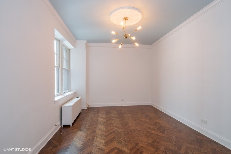 421 West Melrose Street, Unit 5B Chicago, IL 60657 - Photo 11 of 15 wooden floor in an empty room with a window
