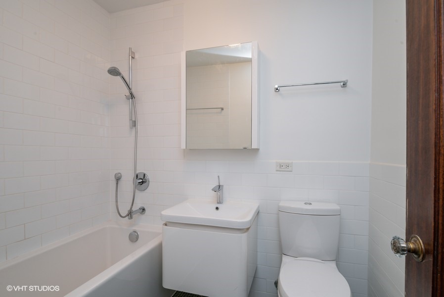 421 West Melrose Street, Unit 5B Chicago, IL 60657 - Photo 13 of 15 a white toilet sitting next to a bath tub