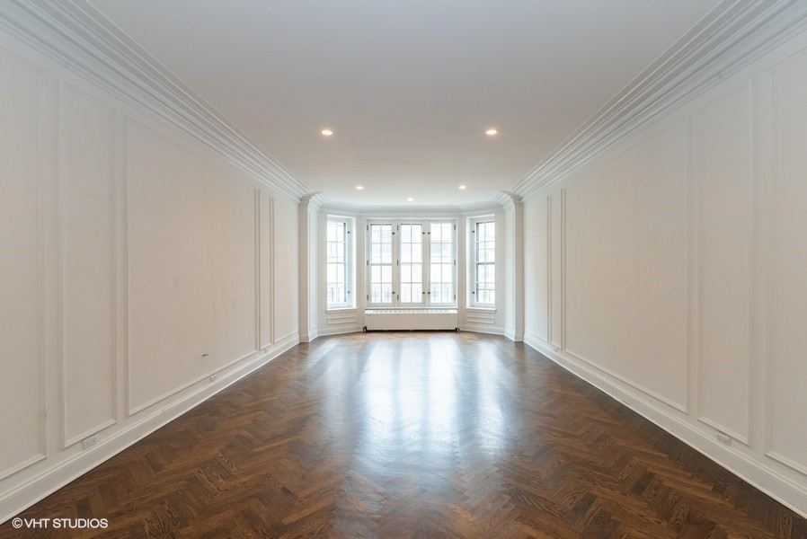 421 West Melrose Street, Unit 5B Chicago, IL 60657 - Photo 5 of 15 a view of an empty room with wooden floor and a window