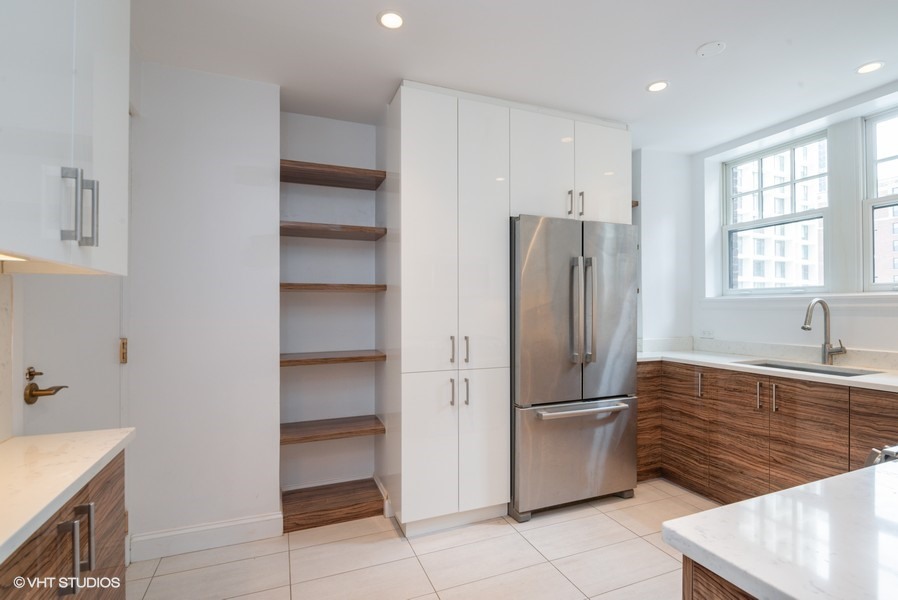 421 West Melrose Street, Unit 5B Chicago, IL 60657 - Photo 6 of 15 a kitchen with a refrigerator and a sink
