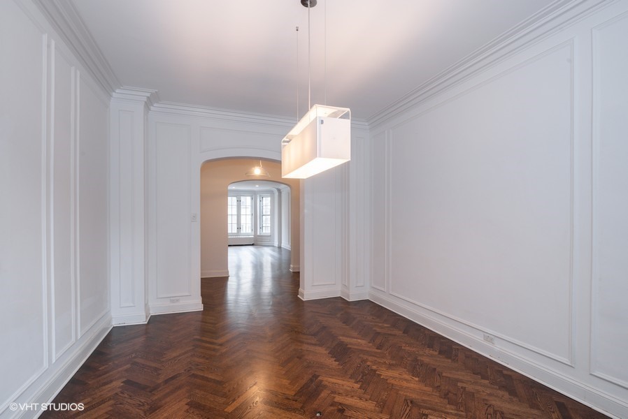 421 West Melrose Street, Unit 5B Chicago, IL 60657 - Photo 8 of 15 a view of an empty room with wooden floor and a window