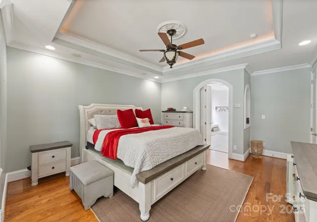 a spacious bathroom with a granite countertop sink a mirror and a shower