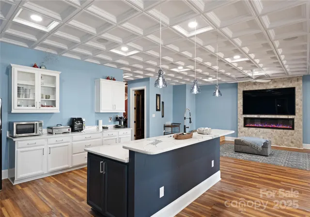 an aerial view of green landscape with trees houses and lake view