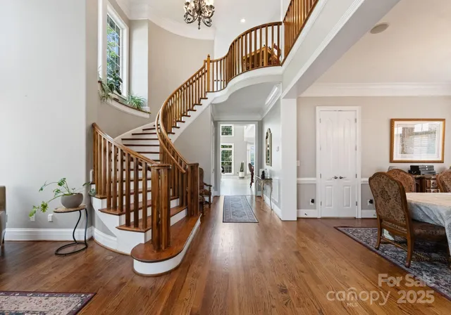 a view of entryway with wooden floor and livingroom