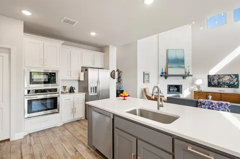 a kitchen with a sink a stove and refrigerator