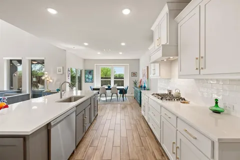 a kitchen with counter top space a sink and appliances