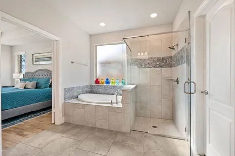 a spacious bathroom with a tub shower and sink